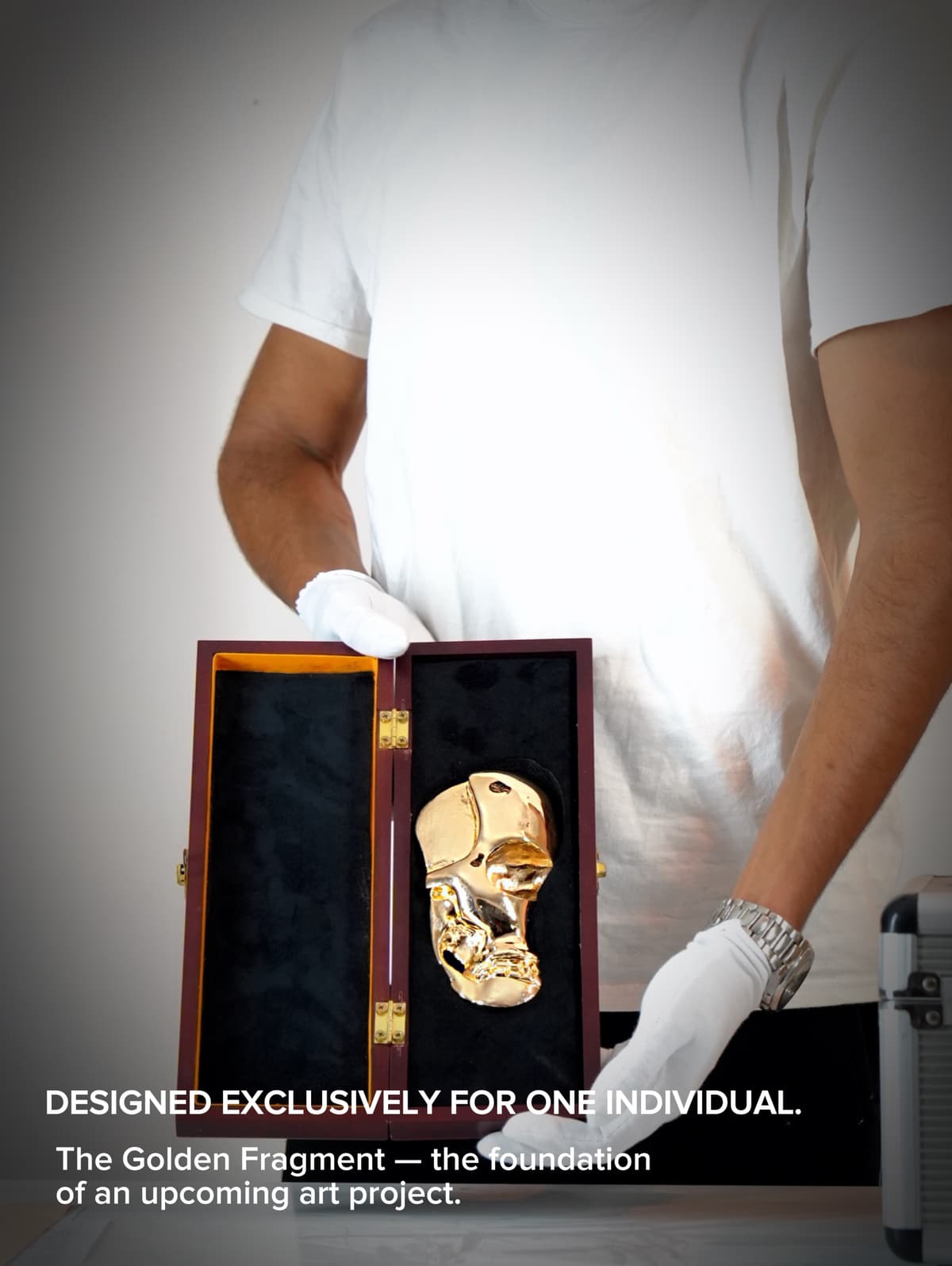 The gold sculpture photographed against a dark background with reflective highlights.